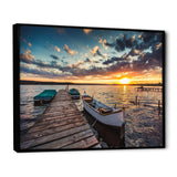 Boats and Jetty under Dramatic Sky