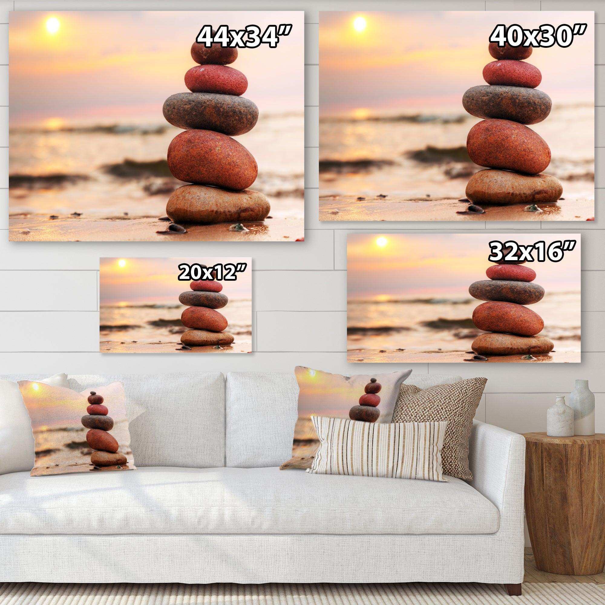 Stones Pyramid on Sand Symbolizing Zen