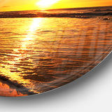 Bright Yellow Sunset over Waves' Beach Metal Circle Wall Art